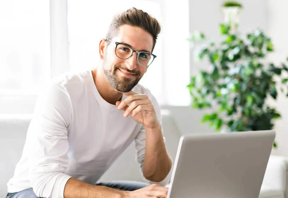 man searching for a therapist online on his laptop computer