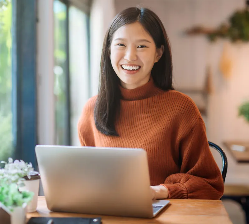 Happy Asian Woman on Computer