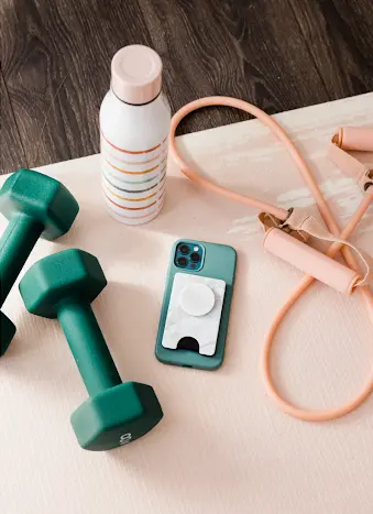 Exercise equipment and a cell phone on a yoga mat