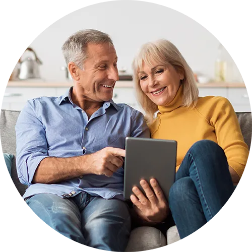 couple sitting on the couch together completing a couples therapy session virually with an online therapist