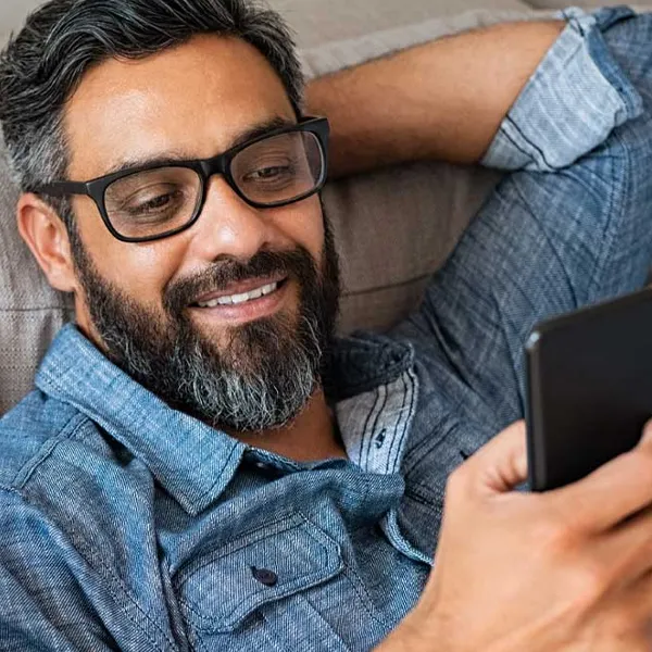 man talking on phone with therapist via facetime