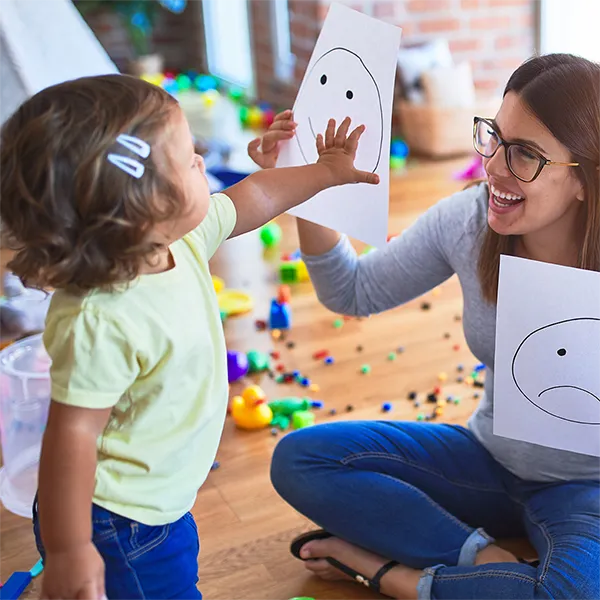 child and therpiast in a play therapy session