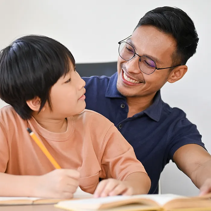 father and son working on homework together